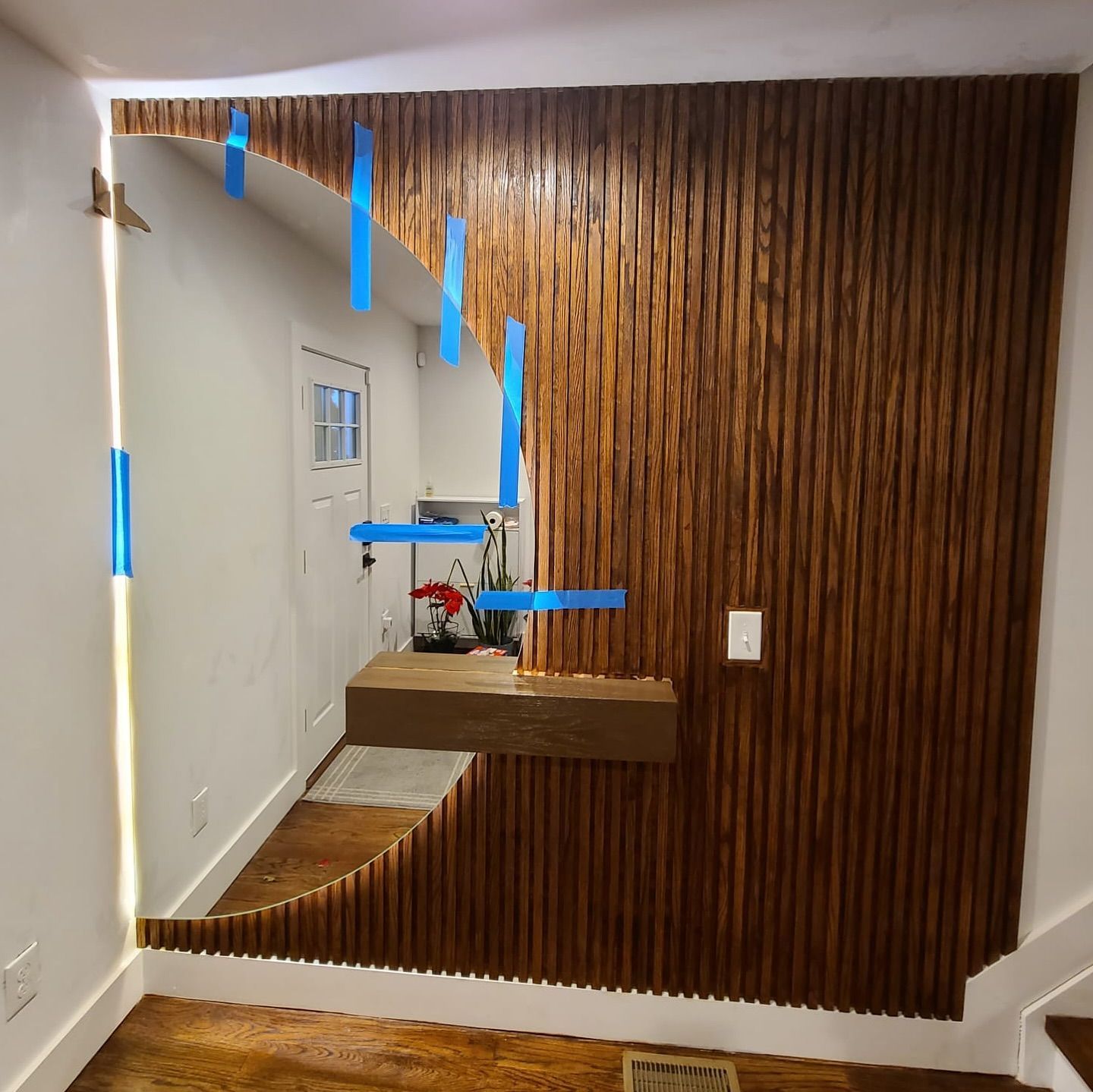 A room with a wooden wall and a mirror