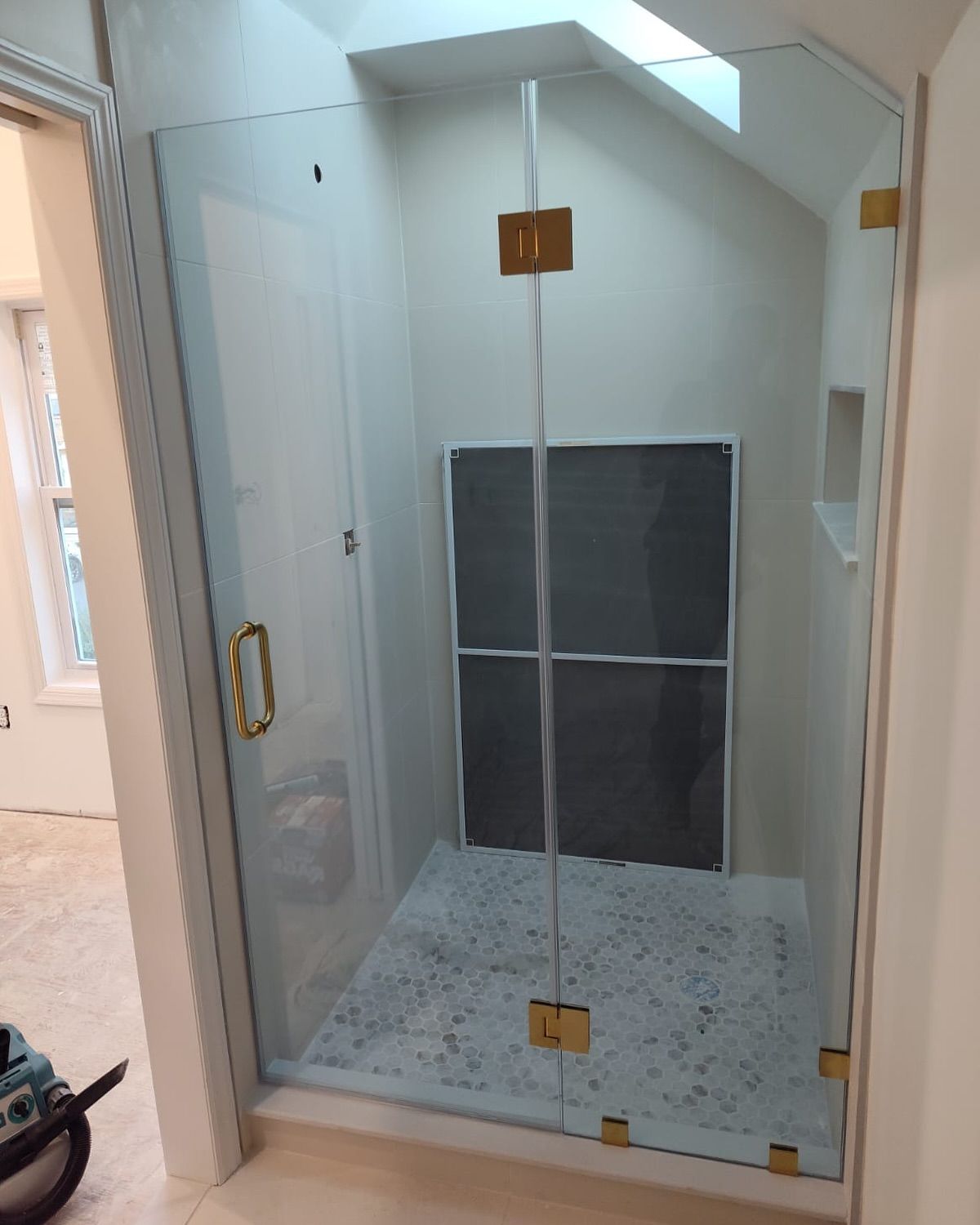A bathroom with a glass shower door and a screen door