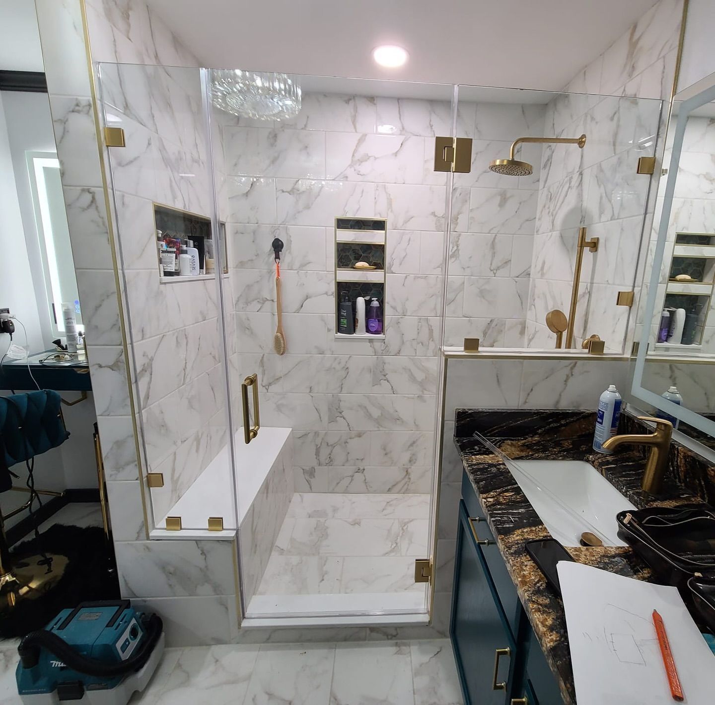 A bathroom with a walk in shower and a sink