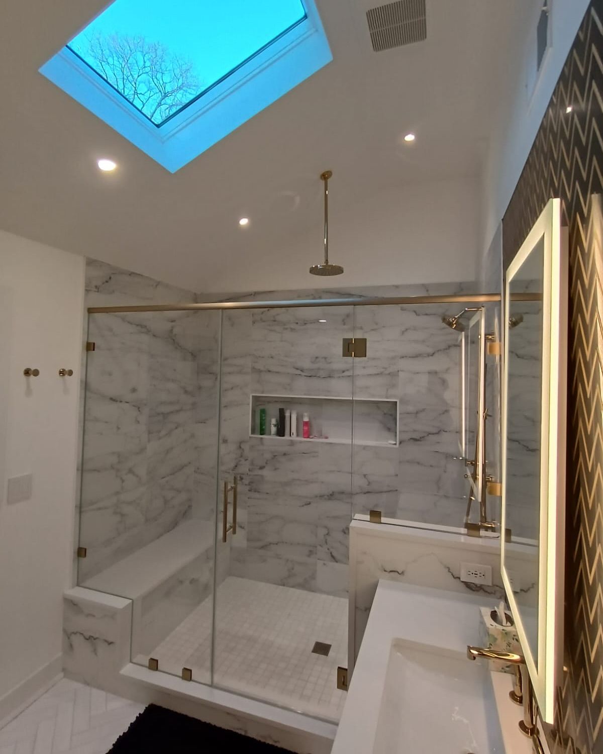 A bathroom with a skylight above the shower