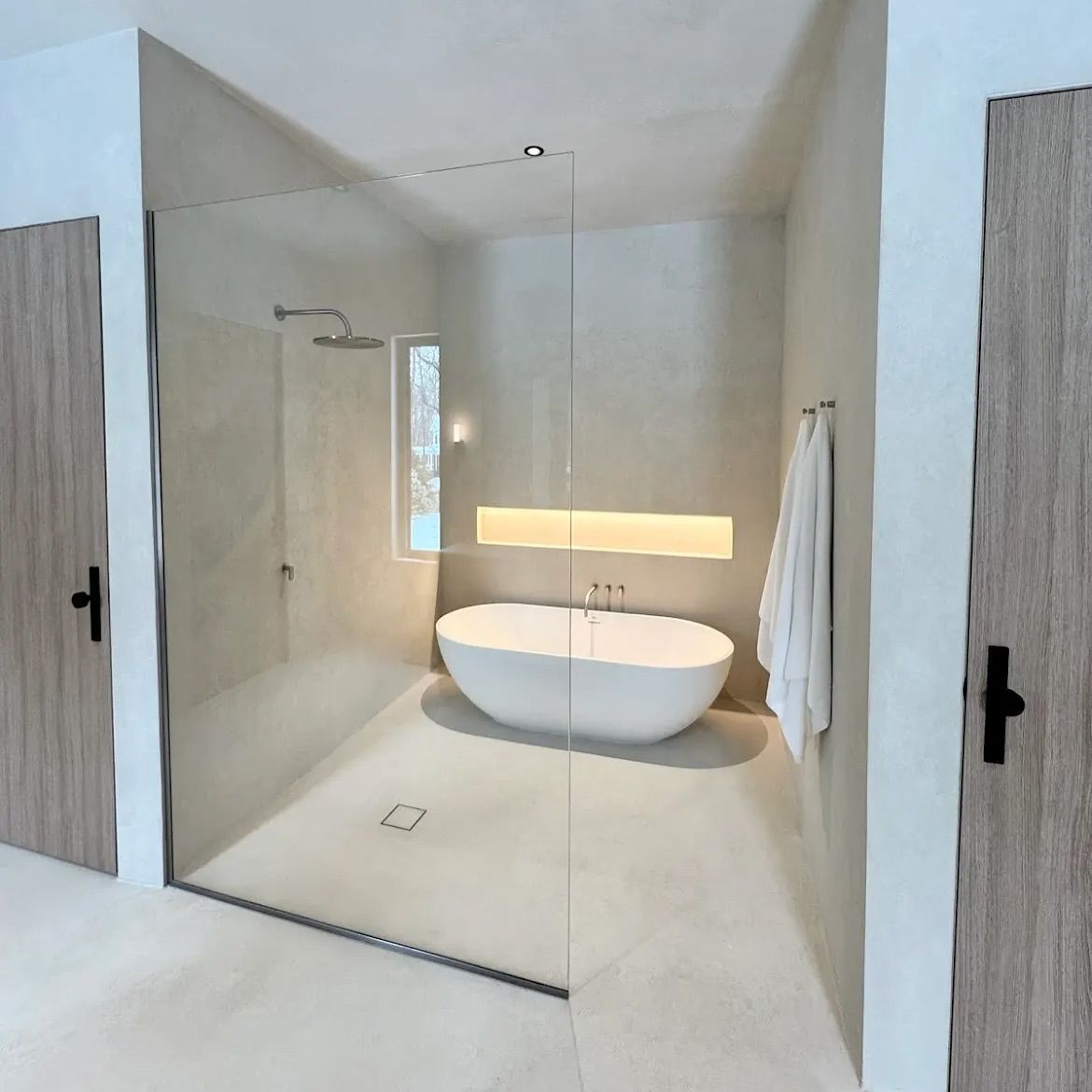 A bathroom with a bathtub and a walk in shower