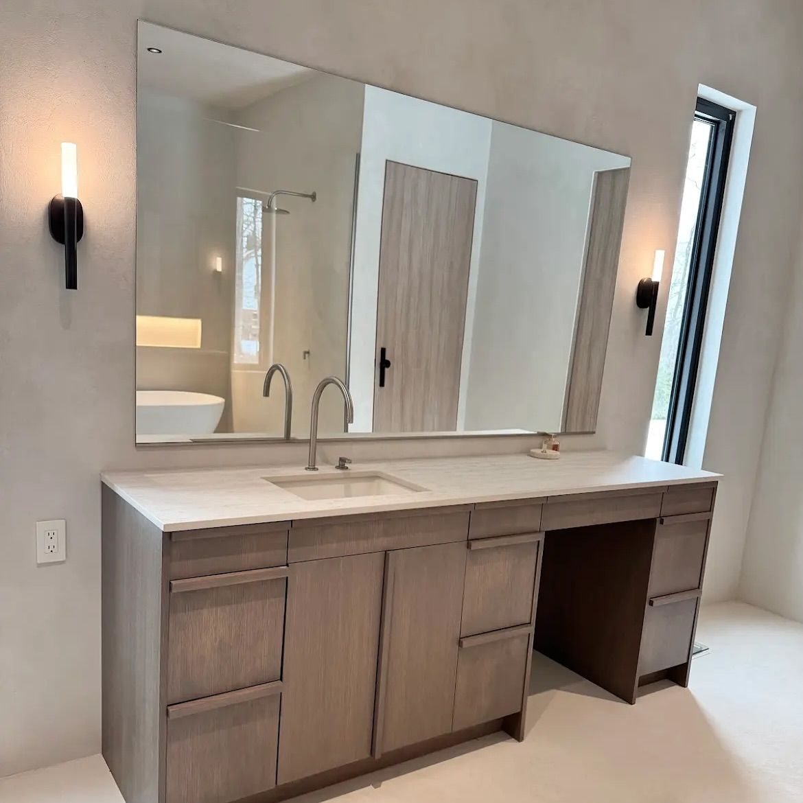 A bathroom with two sinks and a large mirror