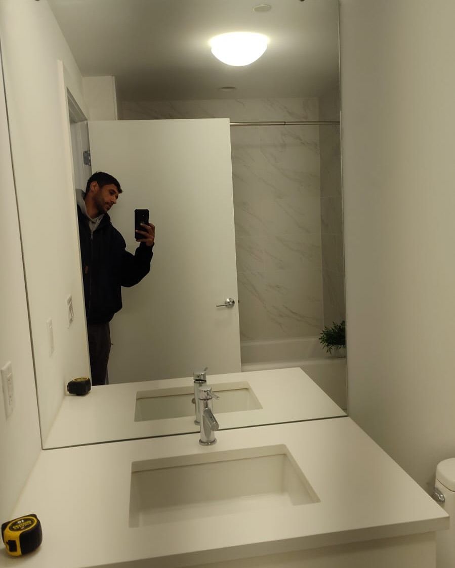 A man taking a picture of himself in a bathroom mirror