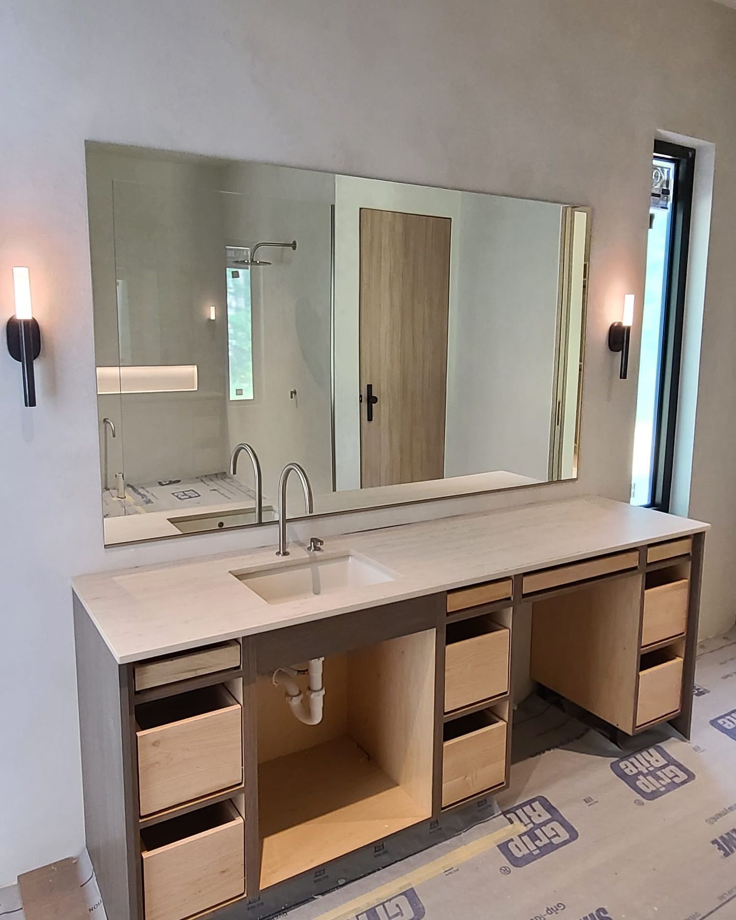 A bathroom with a sink and a large mirror