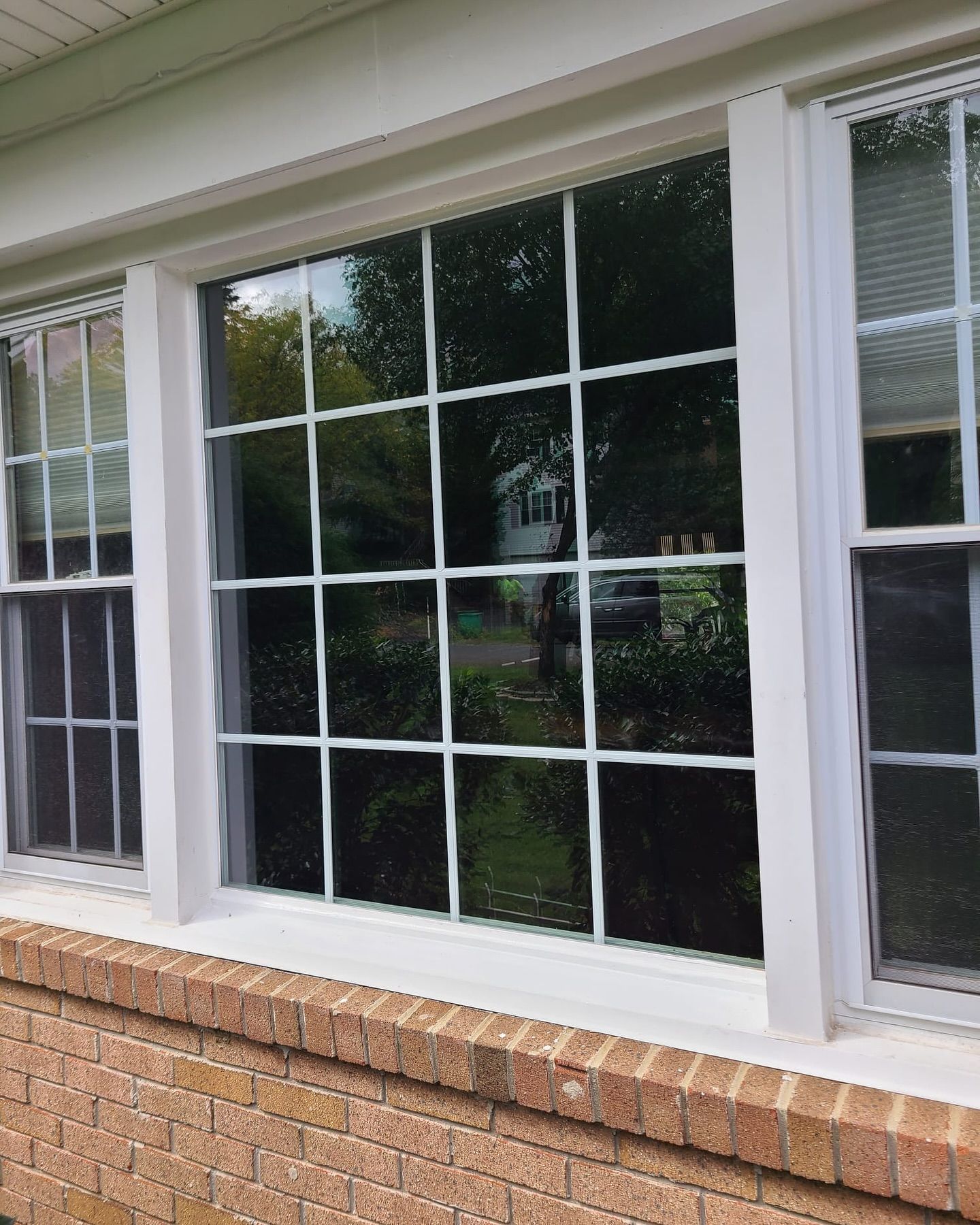 A house with a lot of windows and a brick wall.