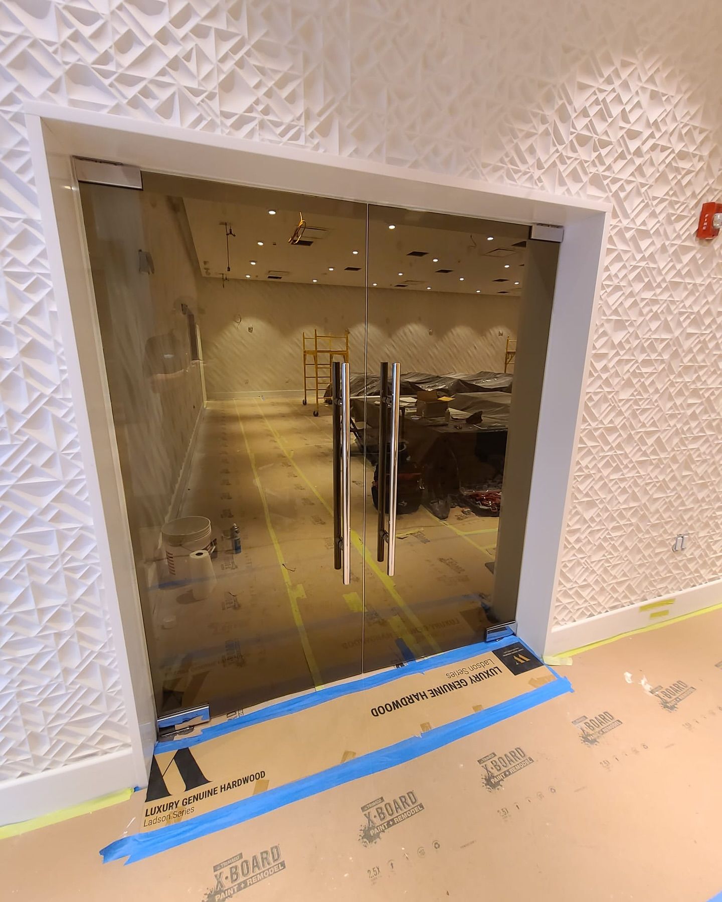 A glass door is being installed in a building.