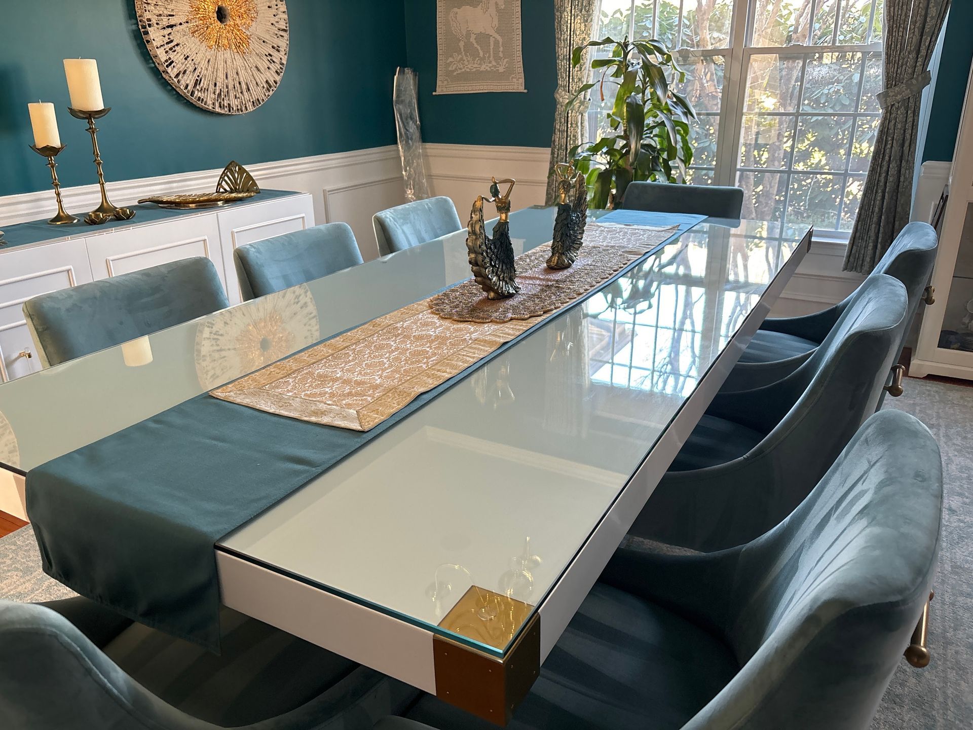 A dining room with a glass table and chairs.