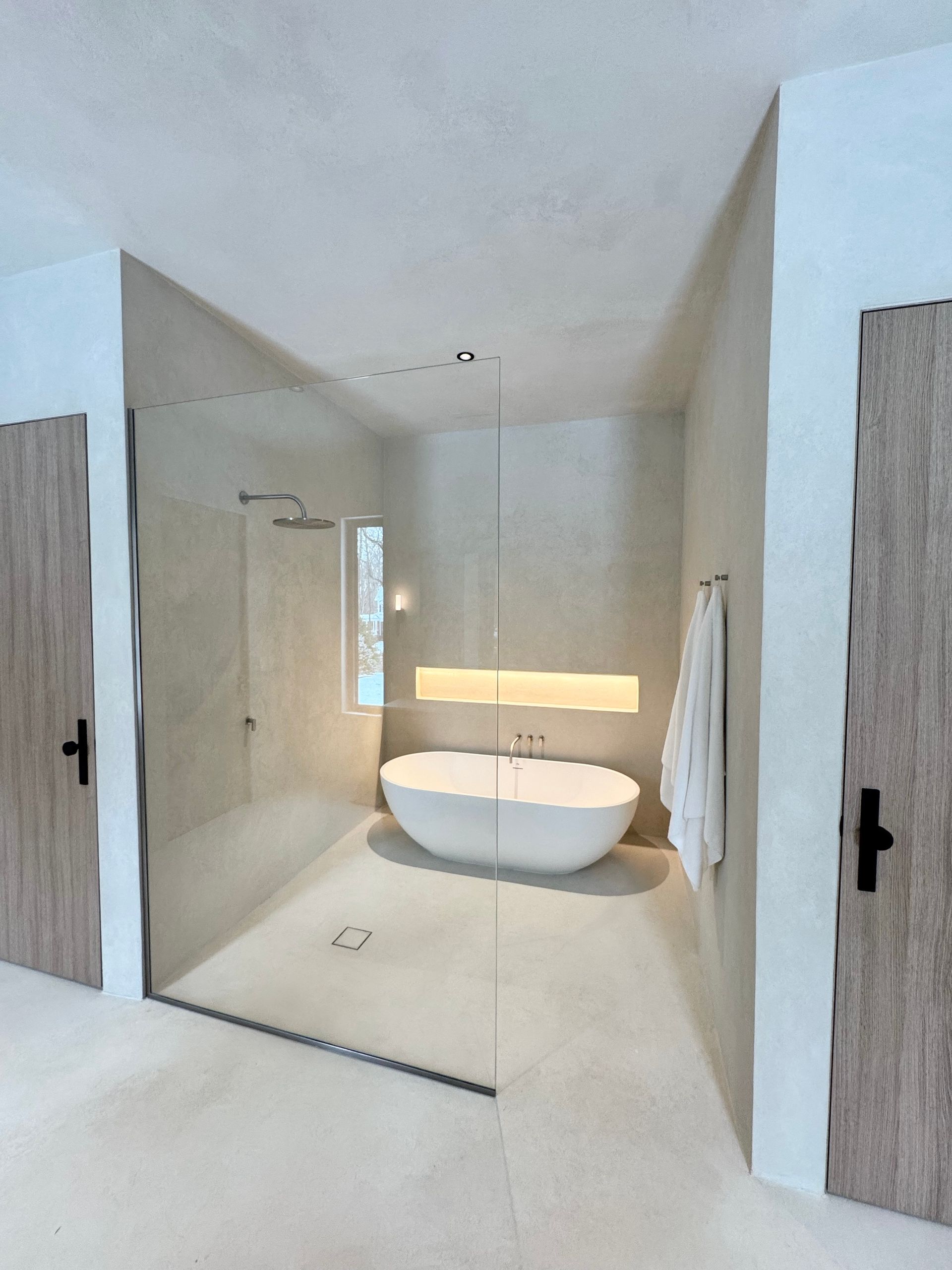 A bathroom with a bathtub and a walk in shower