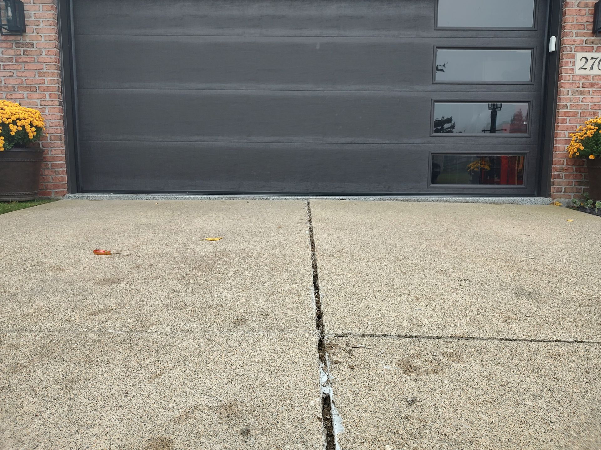 Driveway is down on the left and right at the garage floor