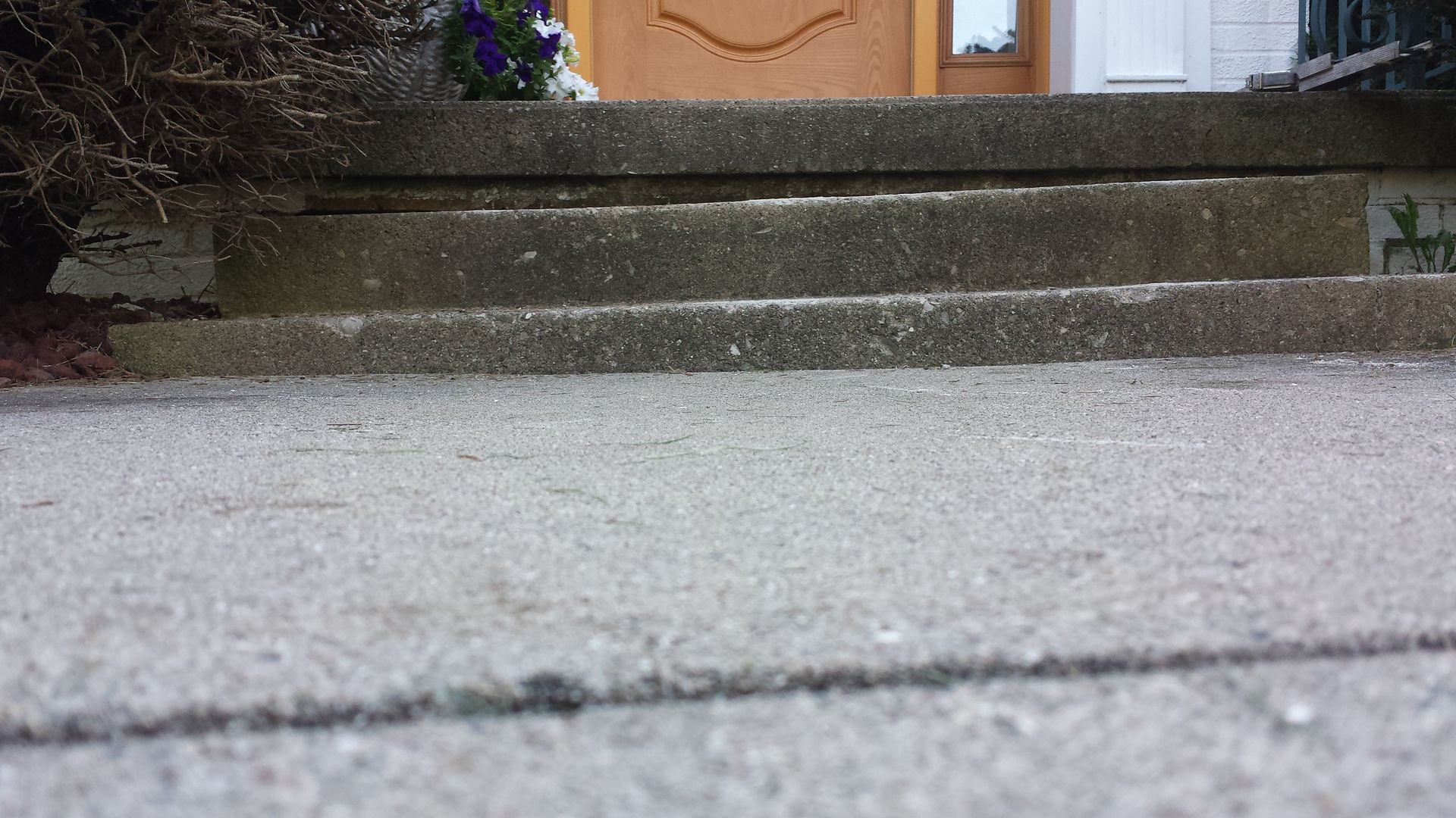 Irwin Concrete Leveling - Before Mudjacking the steps are landing towards the left with uneven step heights