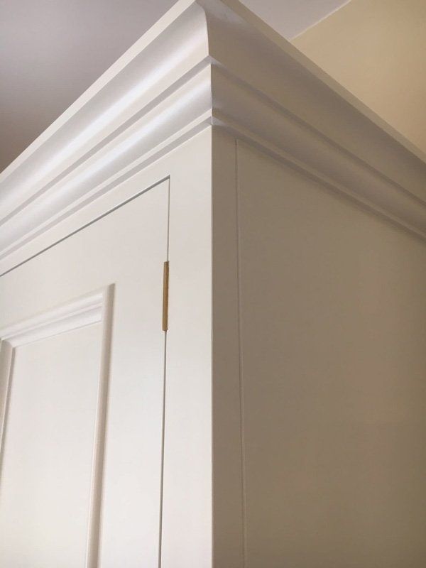 A white fitted wardrobe