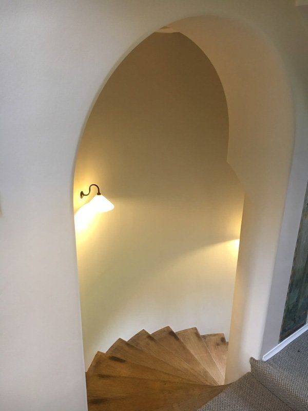 White walls and a natural wood curved staircase