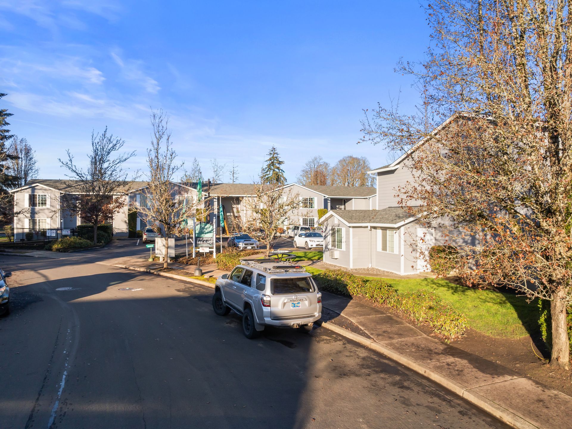 A car is parked on the side of the road in a residential area.