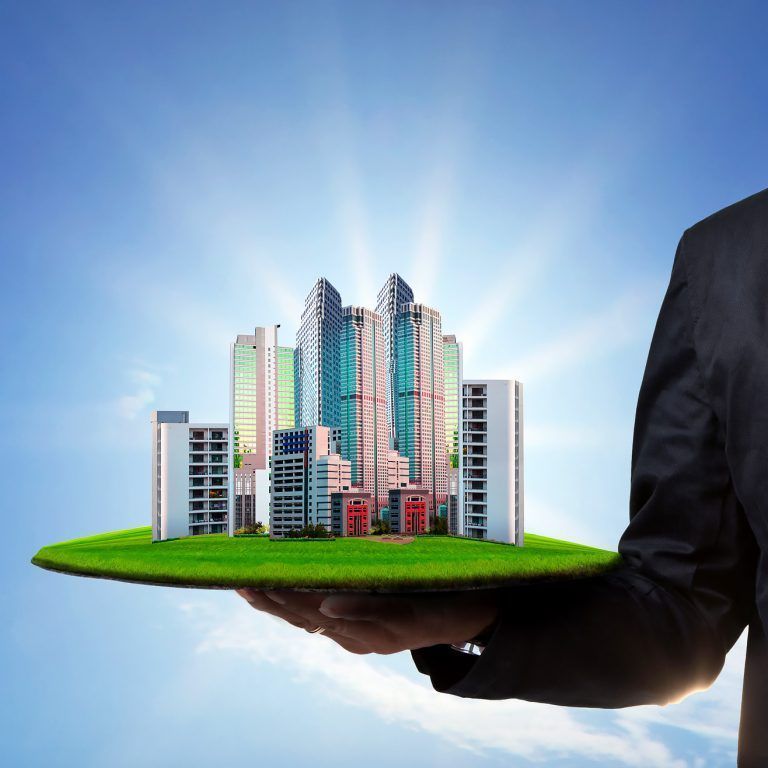 a man is holding a tray with a city on it