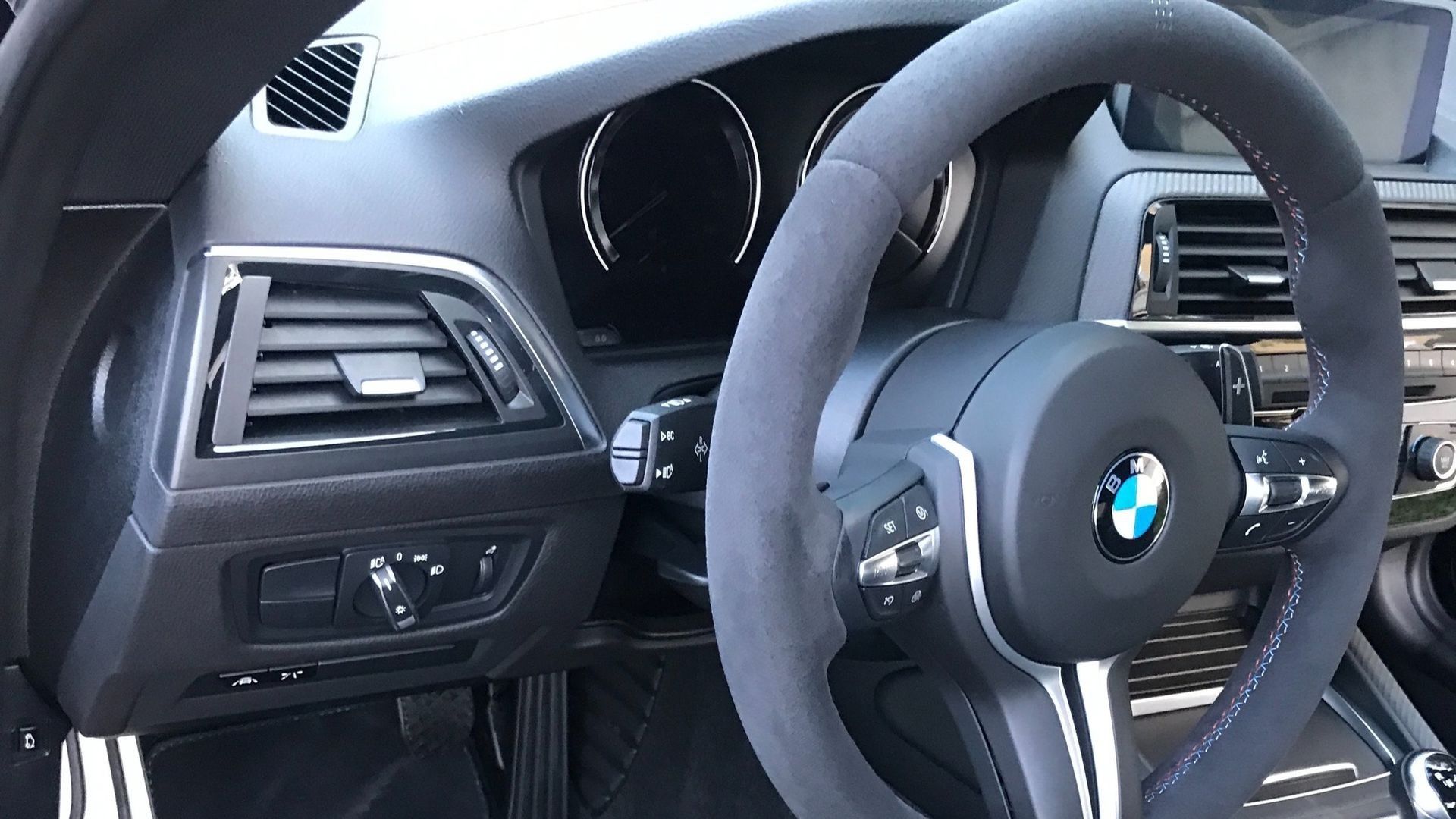 The interior of a bmw with a steering wheel