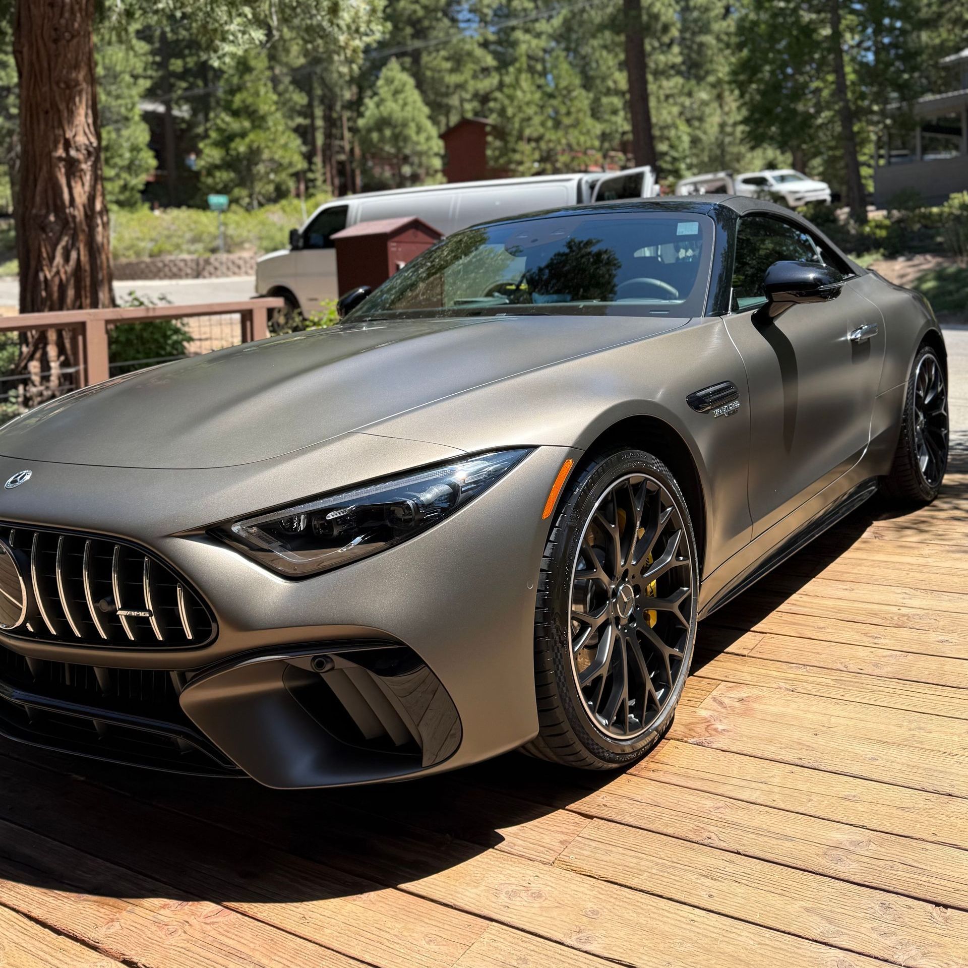 A mercedes benz sl63 amg is parked on a wooden deck.