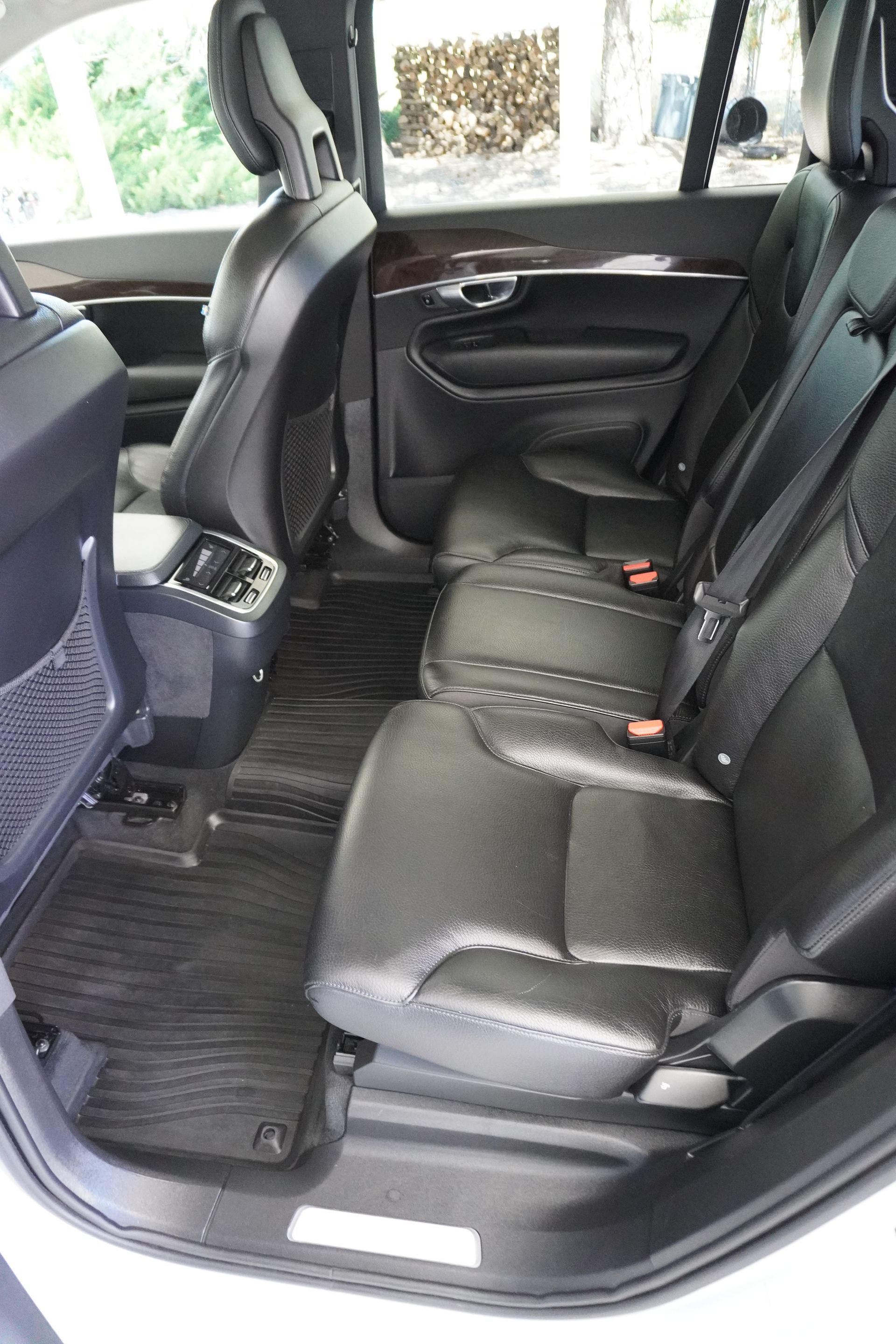 The rear seats of a volvo xc90 are empty.