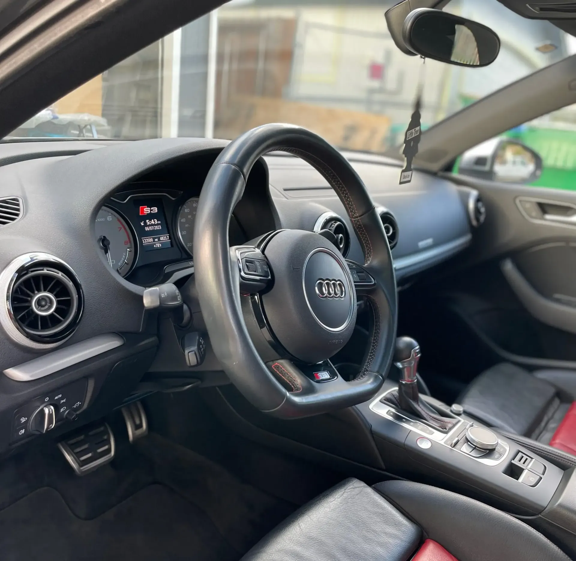 The inside of an audi car with a steering wheel