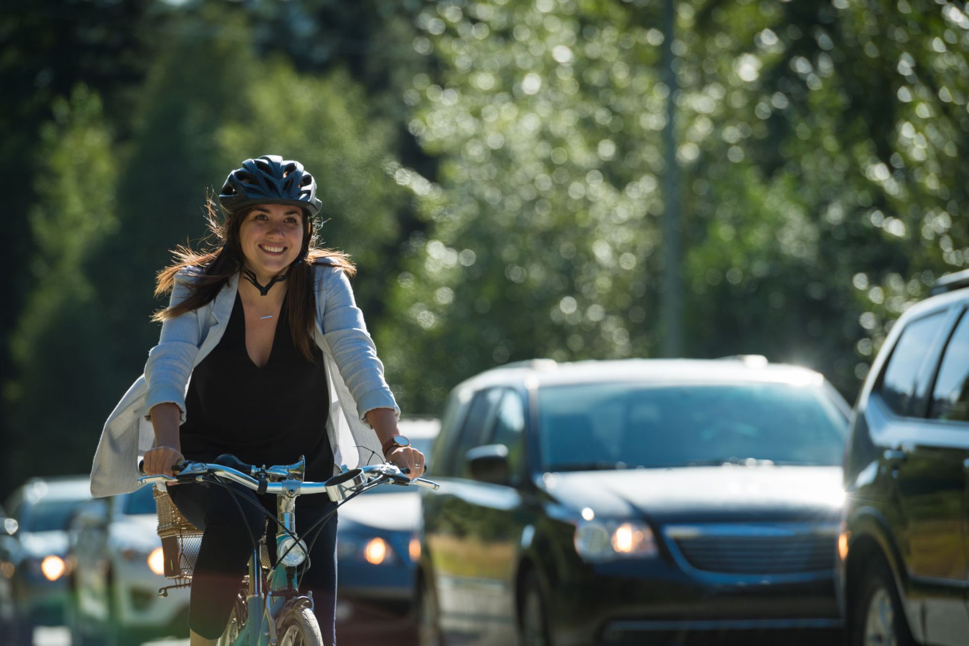 A woman is riding a bike down a busy street.