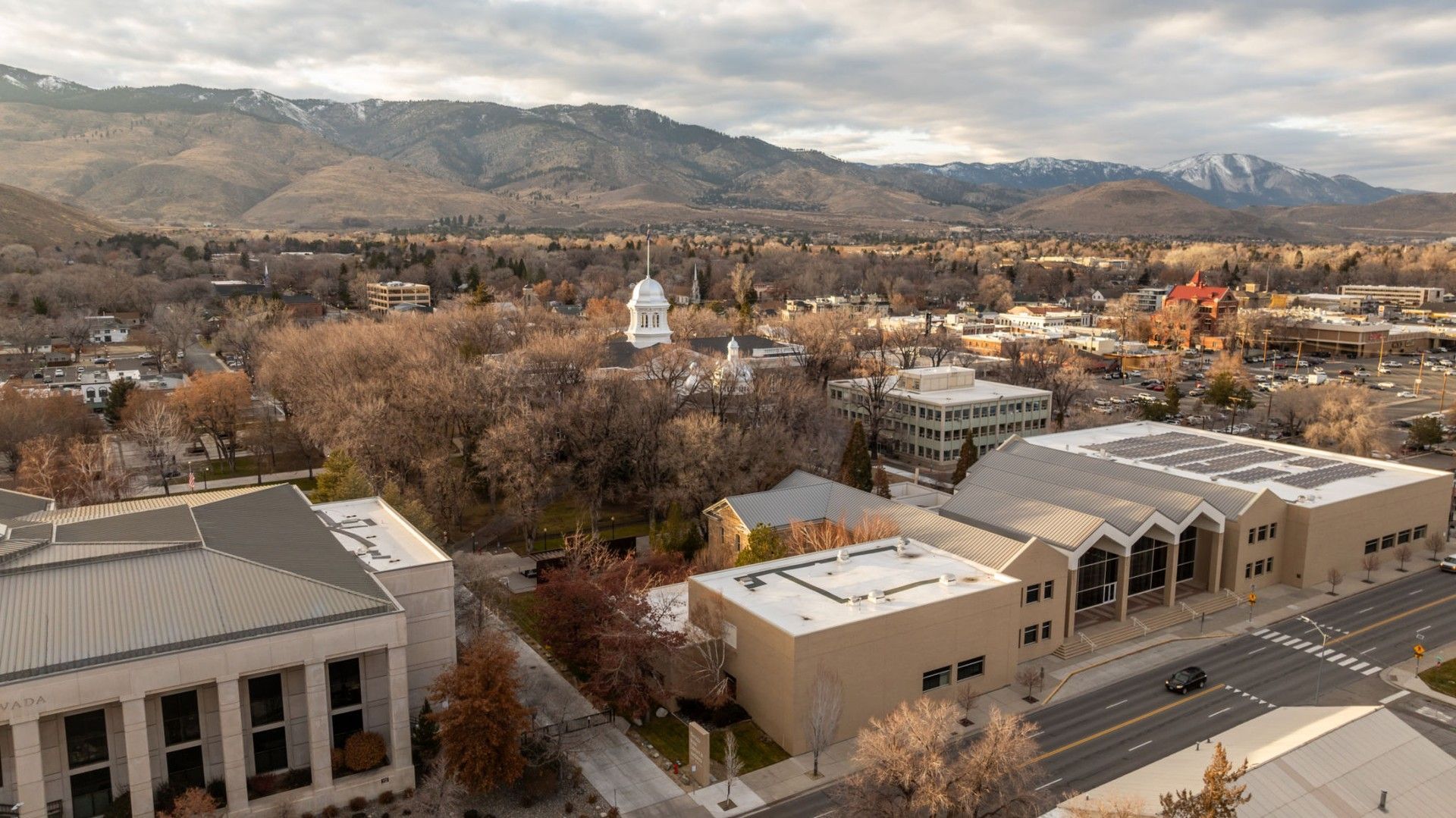 An aerial view of a city with mountains in the background.