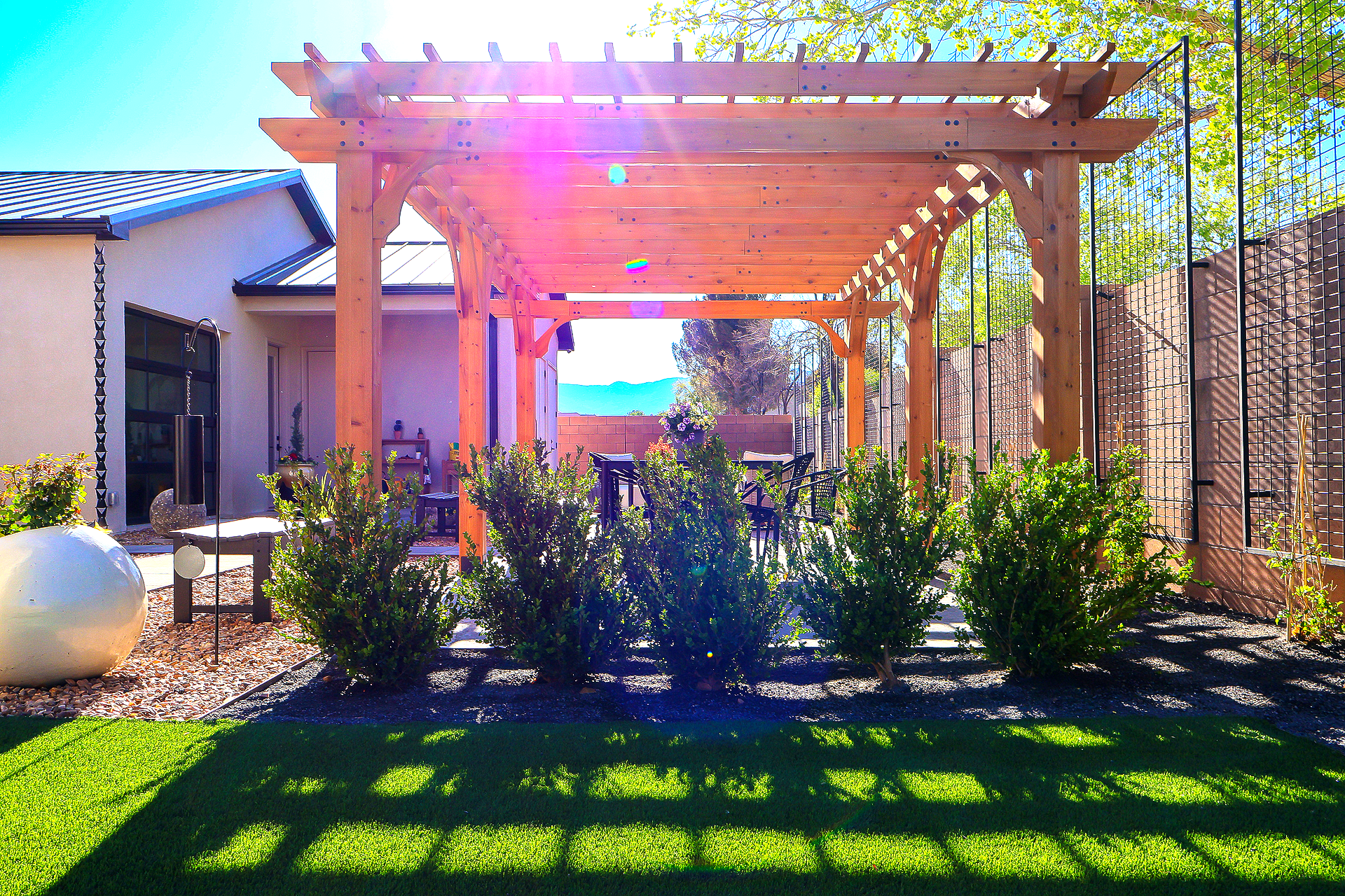 An aerial view of two people mowing a lush green lawn.