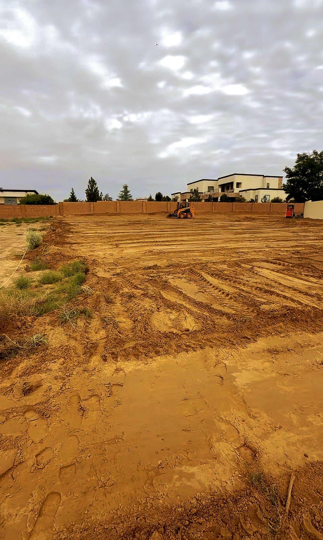 A stump grinder is cutting a tree stump in a yard.