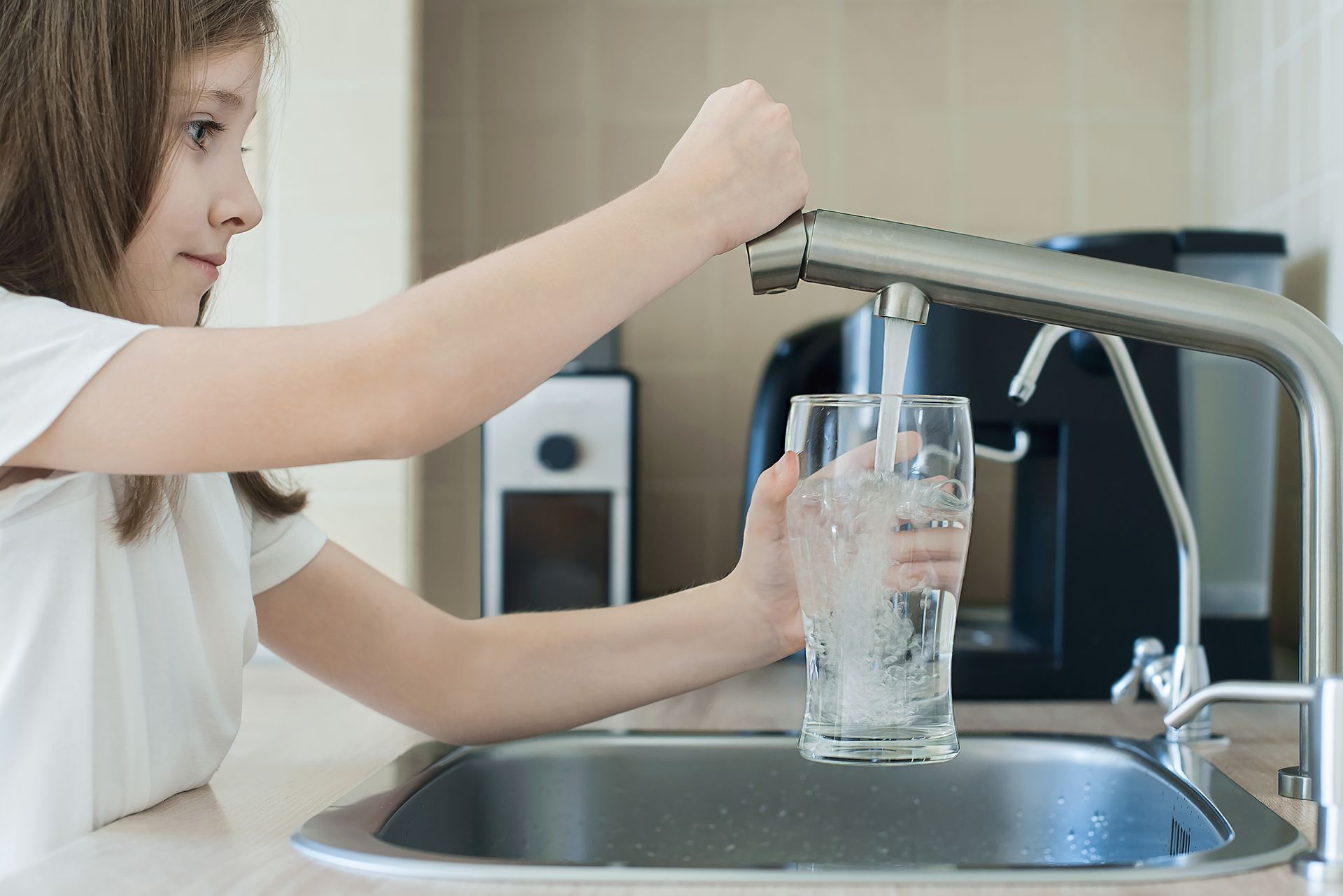 girl filling glass of water