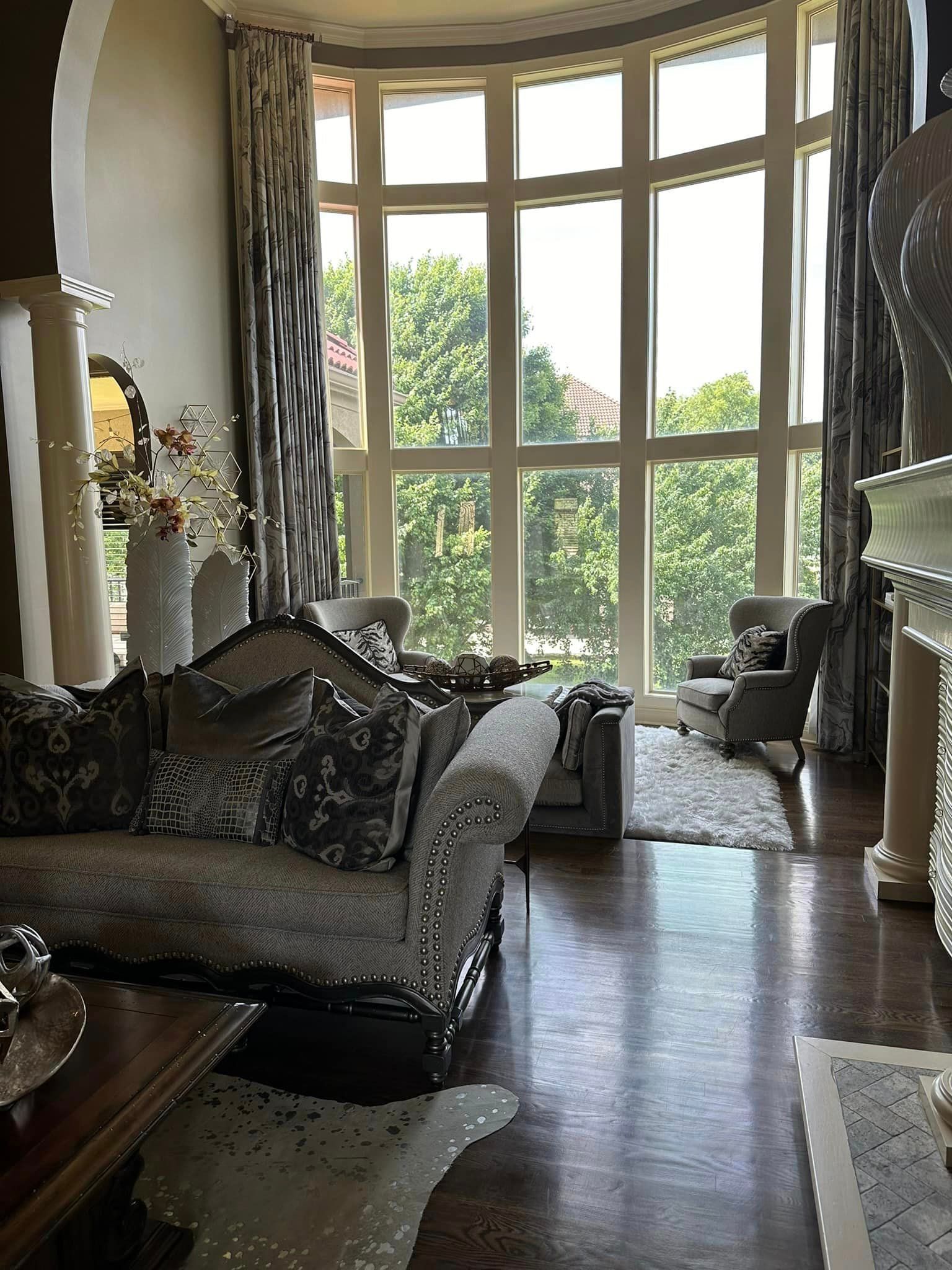A living room with a couch , chairs , and a fireplace.