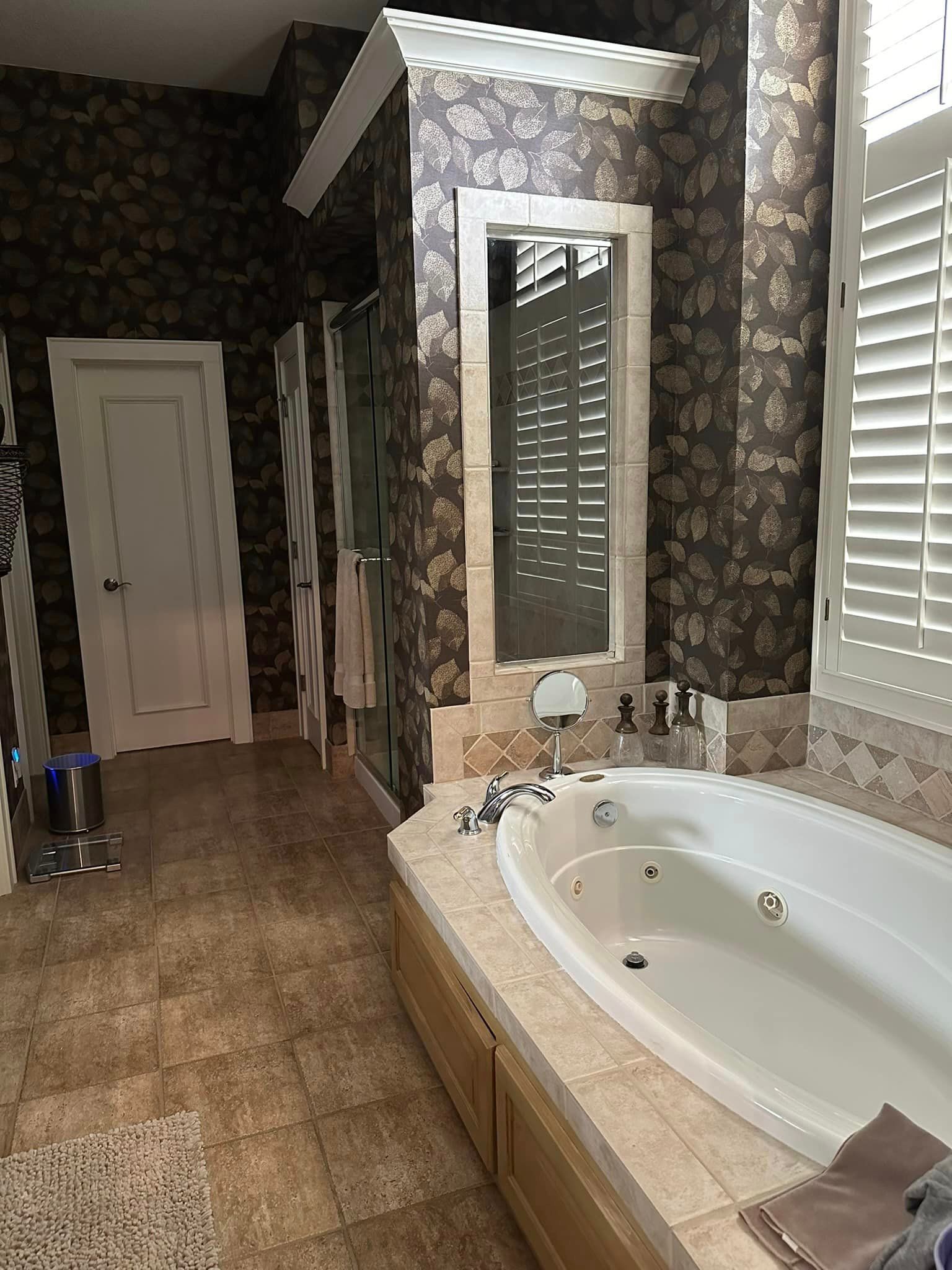 A bathroom with a jacuzzi tub and a mirror.