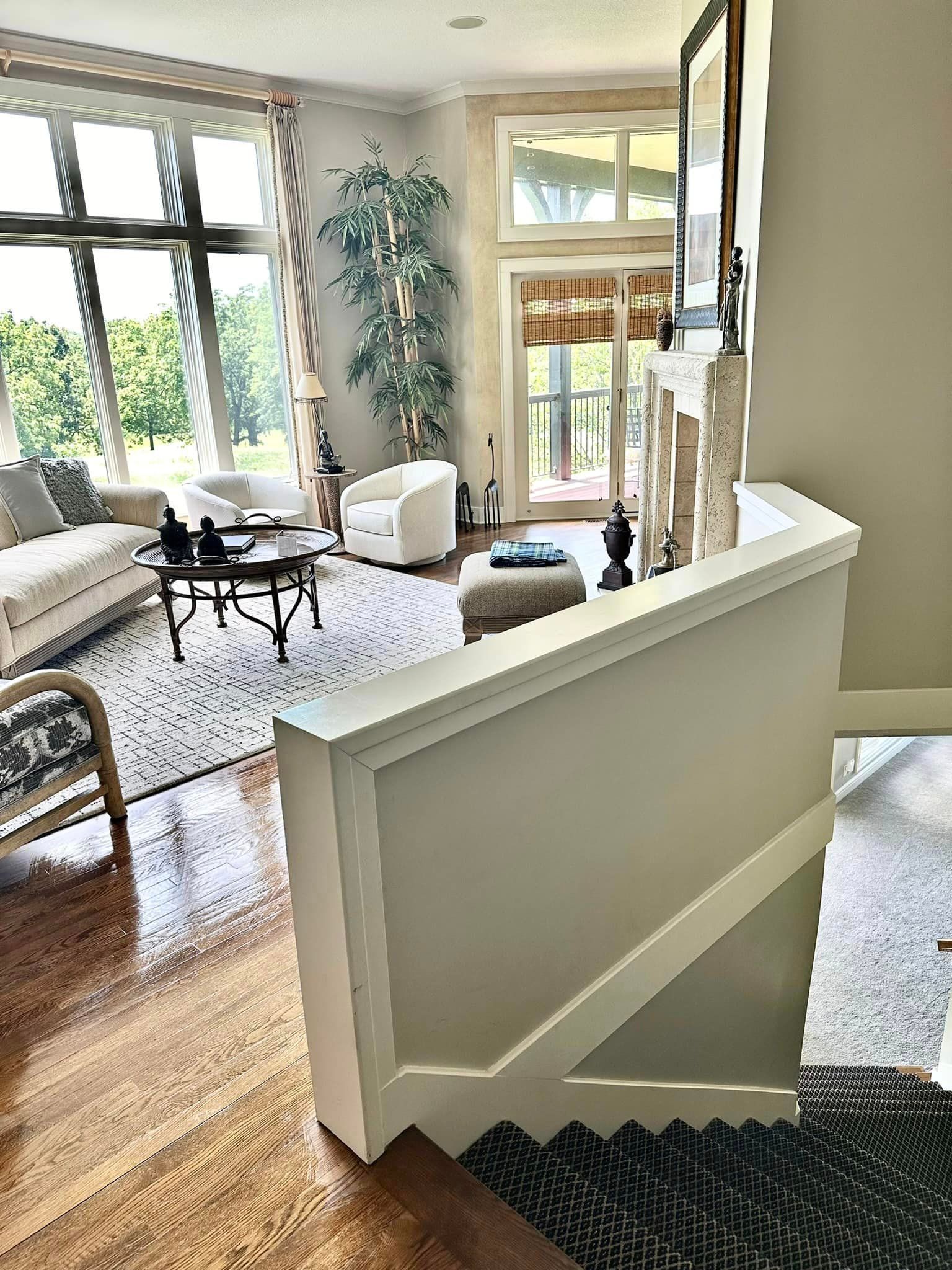 A living room with a staircase leading up to the second floor.