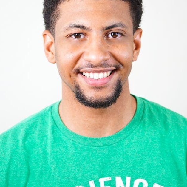 A man wearing a green shirt that says silence