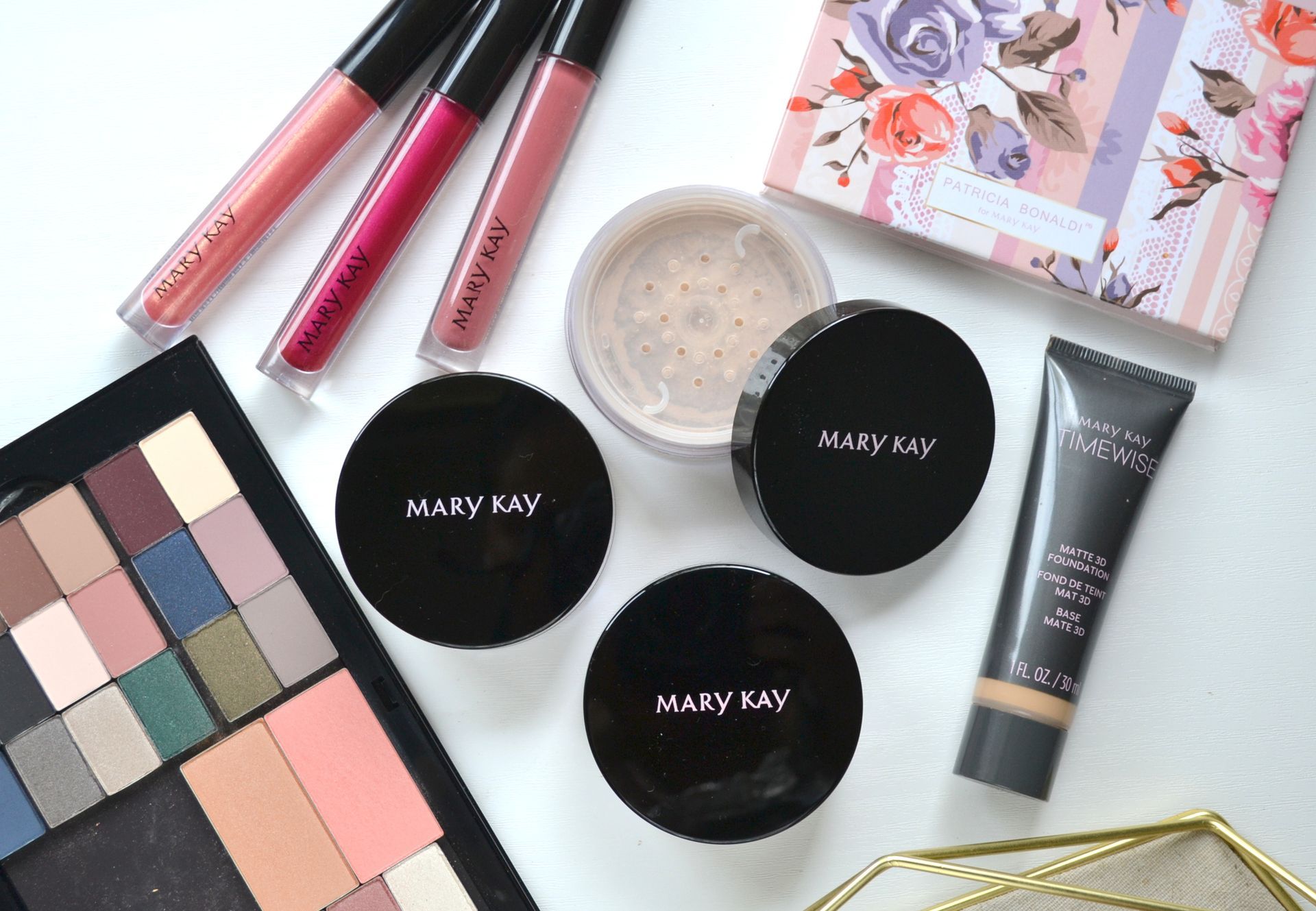 A variety of mary kay makeup products are laid out on a table