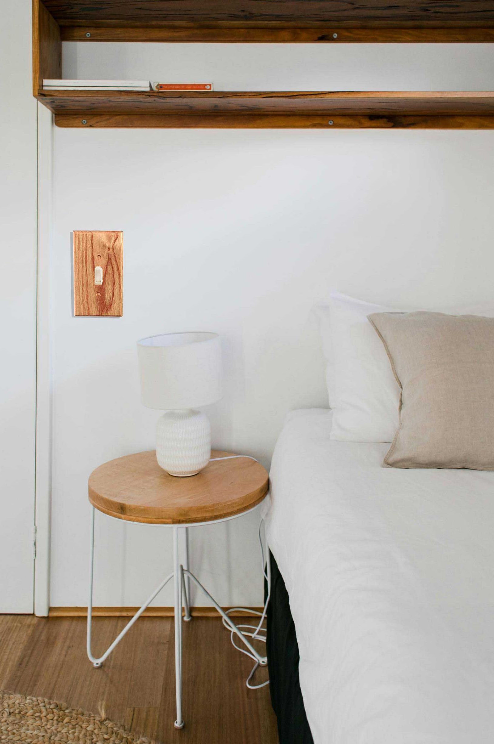 A wall displaying a traditional style wood switch plate.