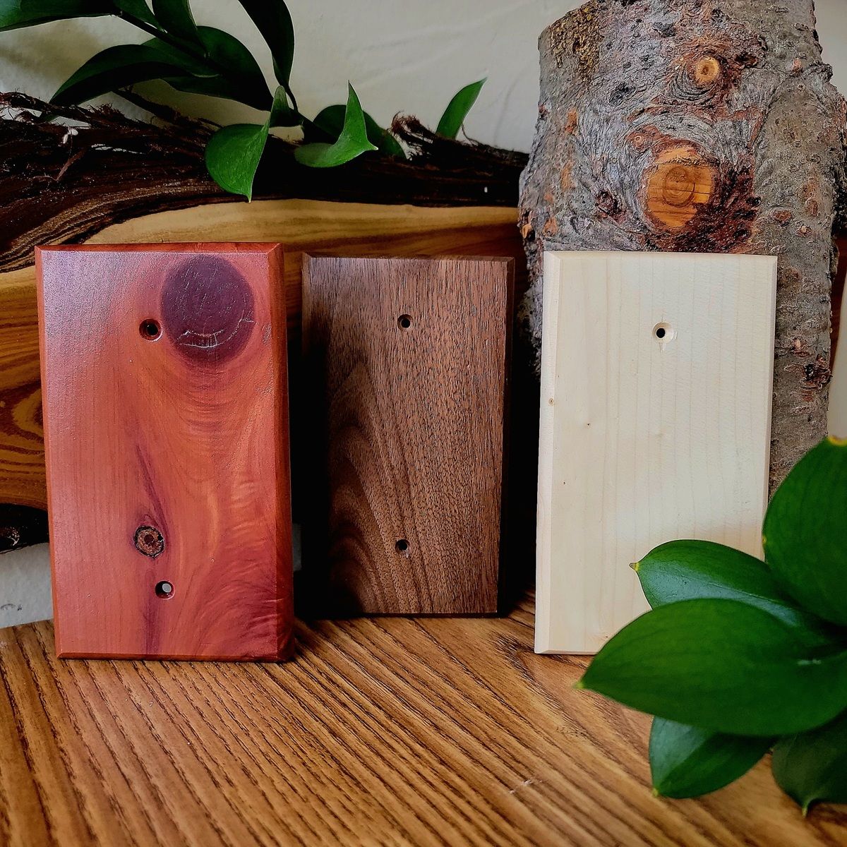 Three different types of wood are sitting on a wooden table