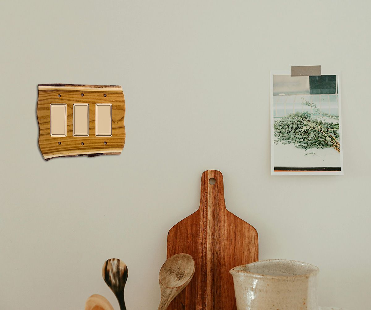 A wall displaying 3 gang rustic switch plate.