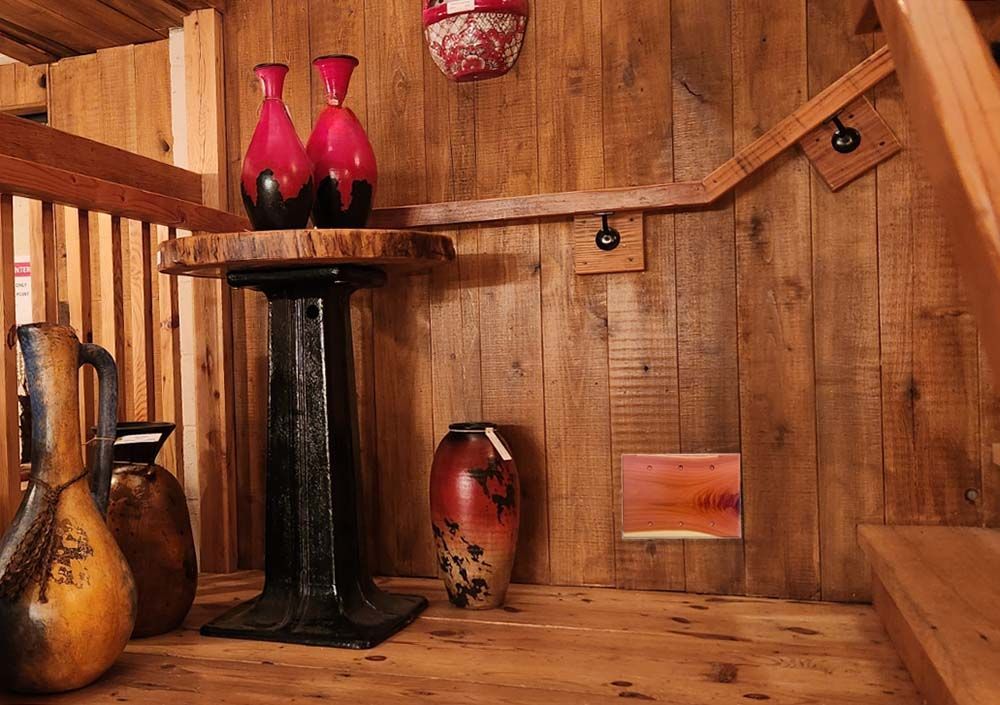 A room with rustic style wall displaying custom 3 gang switch plate cover.