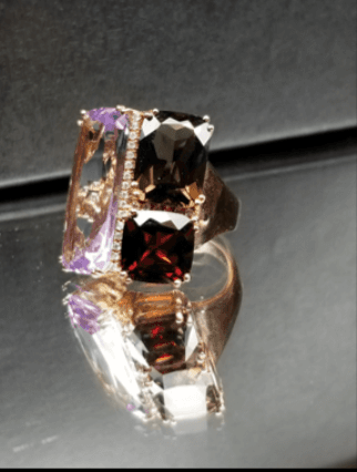 A ring with purple and brown stones on it