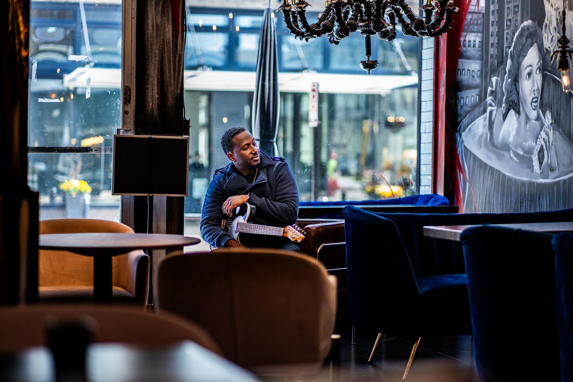 Corey Tucker is sitting at a table in a restaurant.