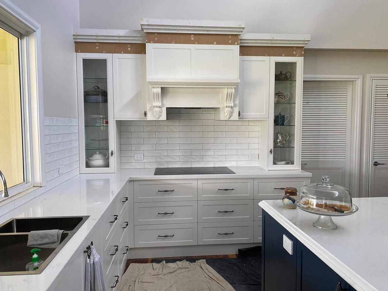 A Kitchen With White Cabinets, a Sink, and a Stove Top Oven — Simmonds Kitchens & Detailed Joinery in Quirindi, NSW