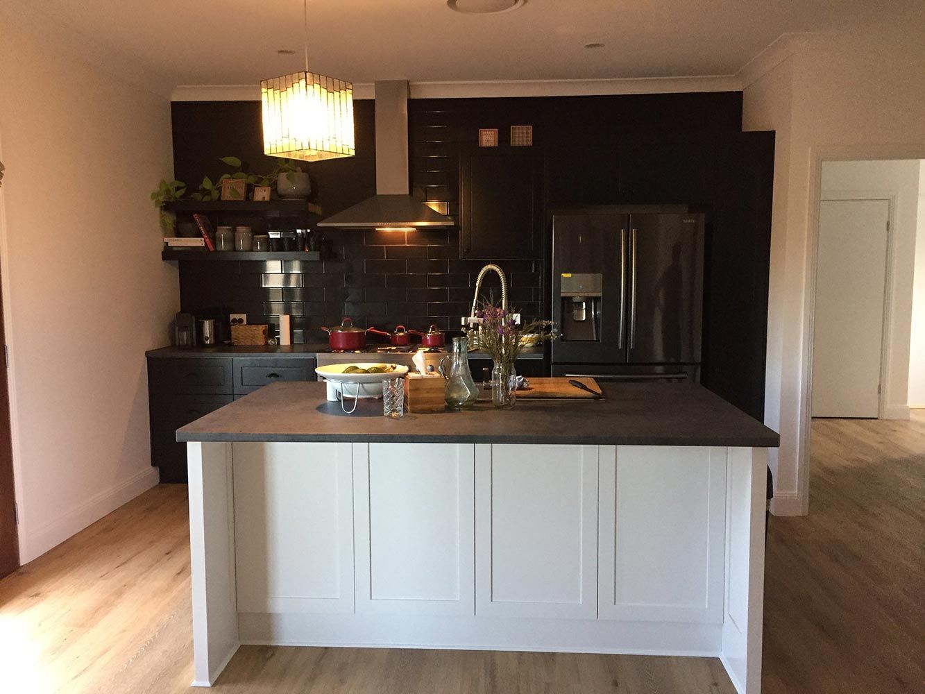 A Kitchen With a Large Island in the Middle and a Refrigerator — Simmonds Kitchens & Detailed Joinery in Narrabri, NSW