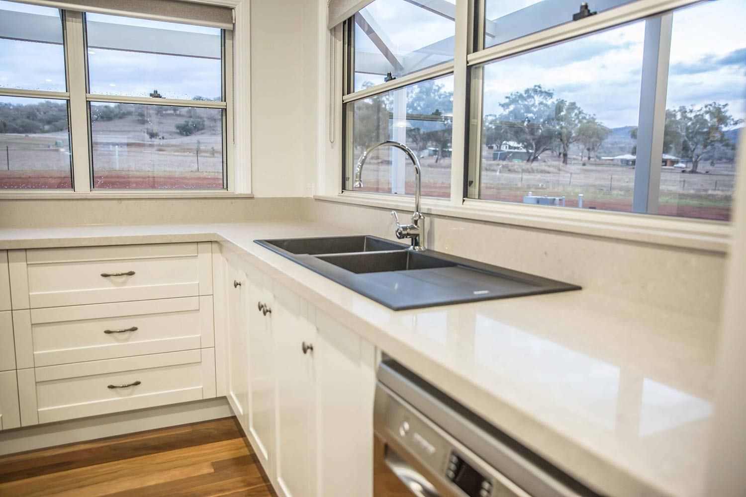 A Kitchen With White Cabinets, a Sink, a Dishwasher, and a Window — Simmonds Kitchens & Detailed Joinery in Tamworth, NSW