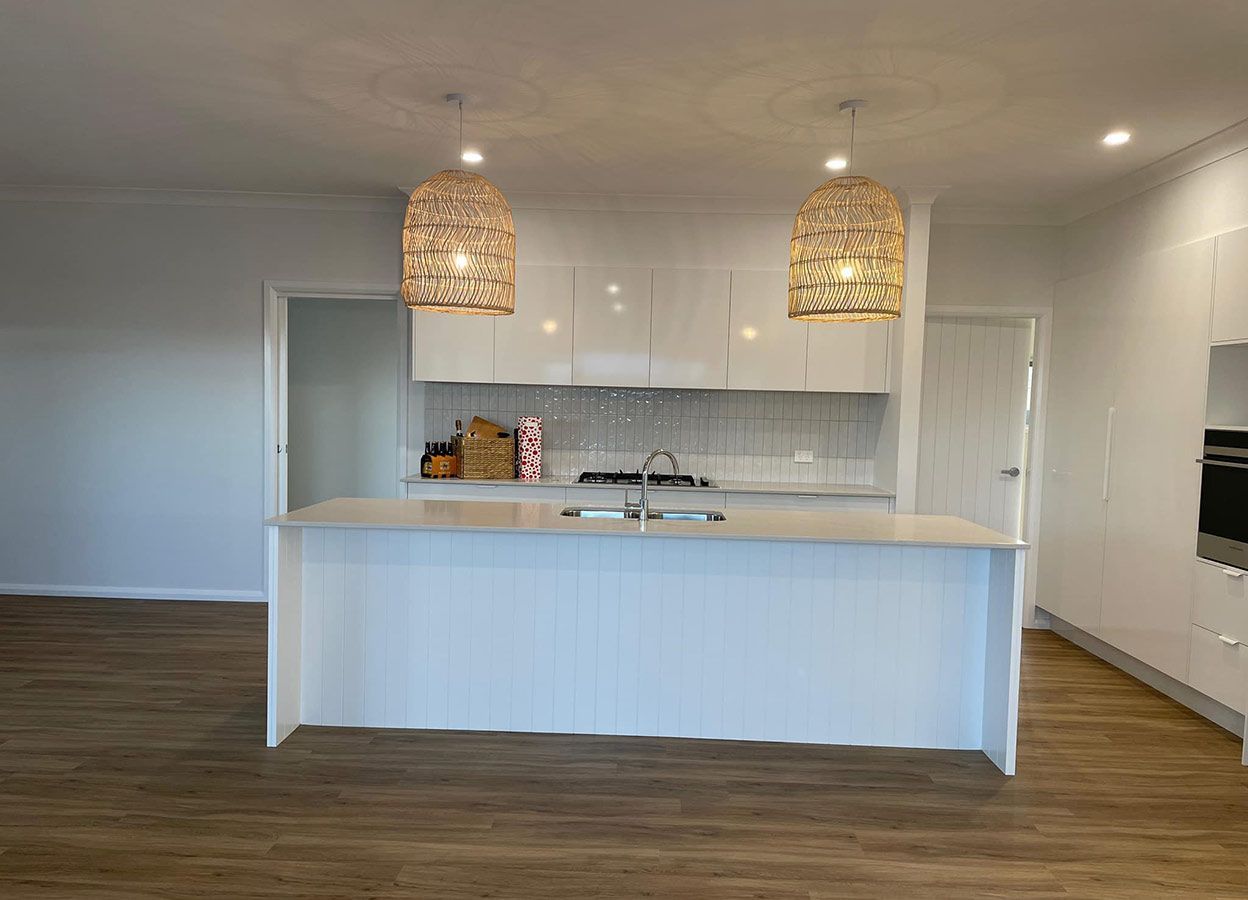 A Kitchen With Cabinets and a Large Island in the Middle of the Room — Simmonds Kitchens & Detailed Joinery in Quirindi, NSW
