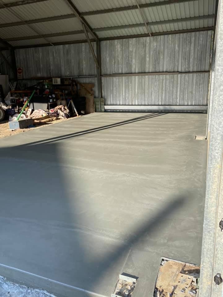 New Concrete Floor Inside a Metal Shed. Sunlight Casts Shadows — Williams Concreting In Wingham, NSW