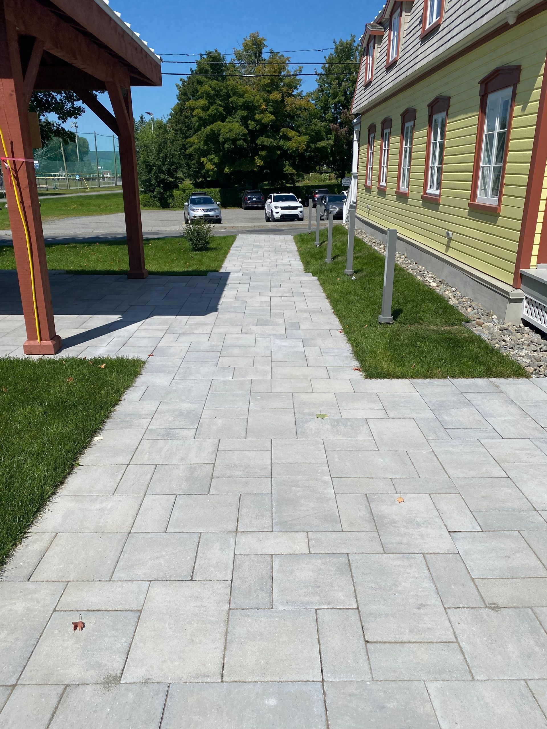 Une passerelle menant à un bâtiment avec des voitures garées devant