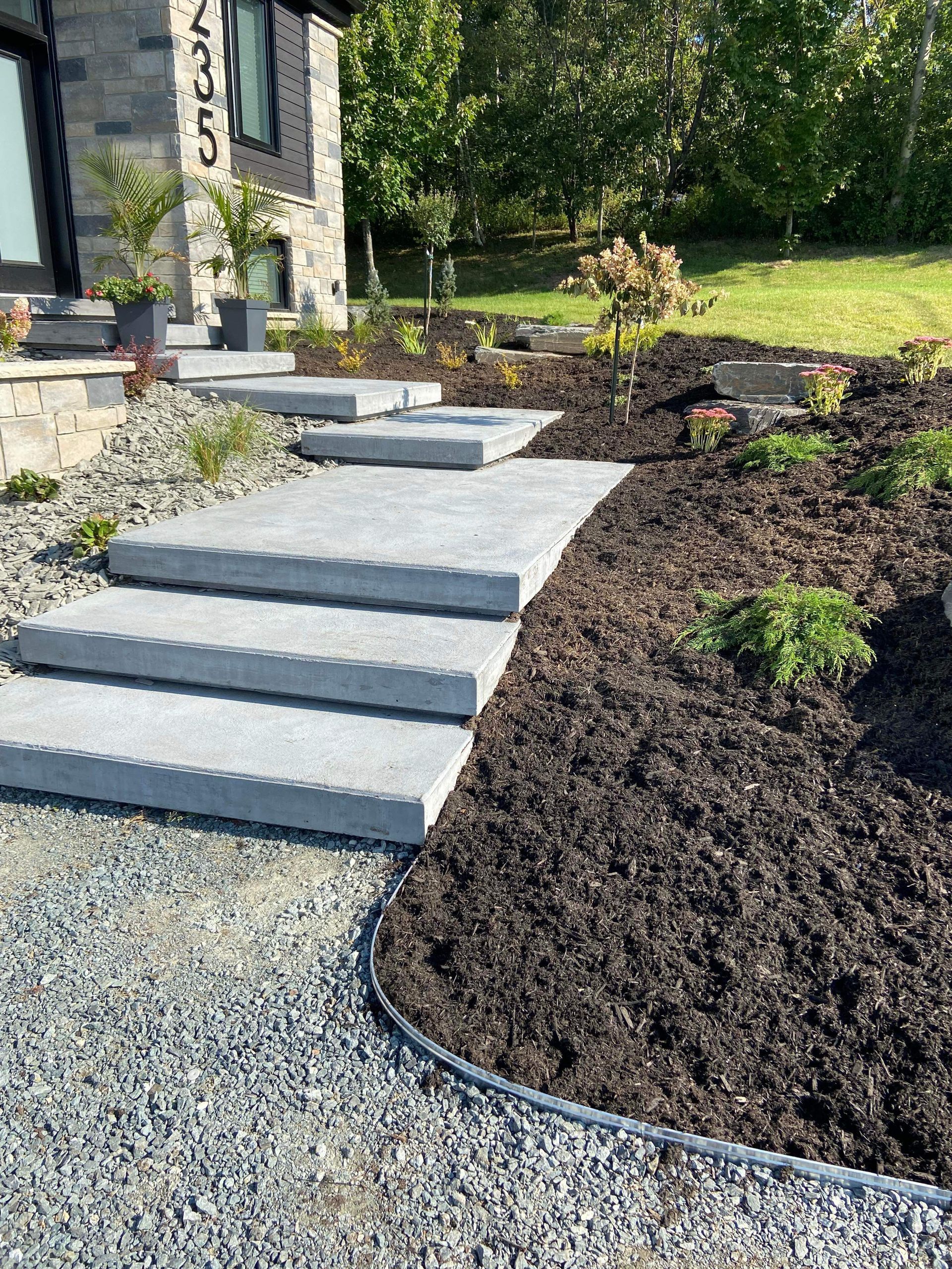 Une allée en pierre avec des marches menant à une maison.