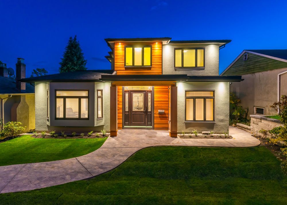 A Large House With A Lot Of Windows Is Lit Up At Night — Settle Petal Mobile Conveyancing In Nabiac, NSW