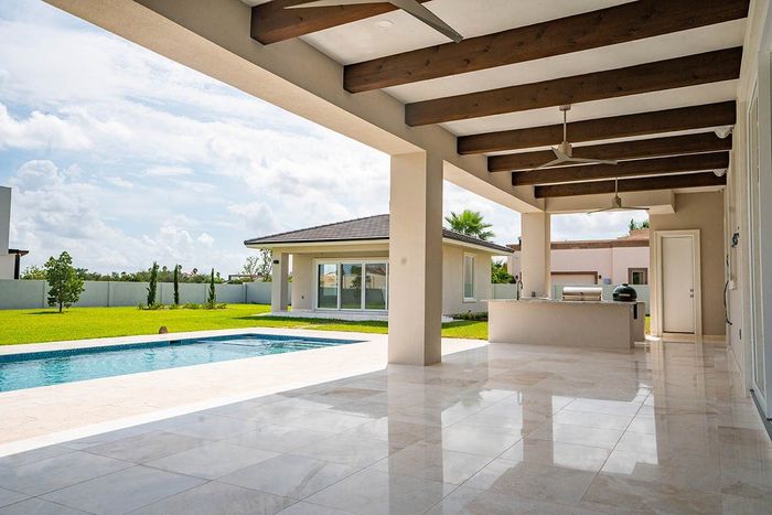 backyard with terrace, pool and large green area