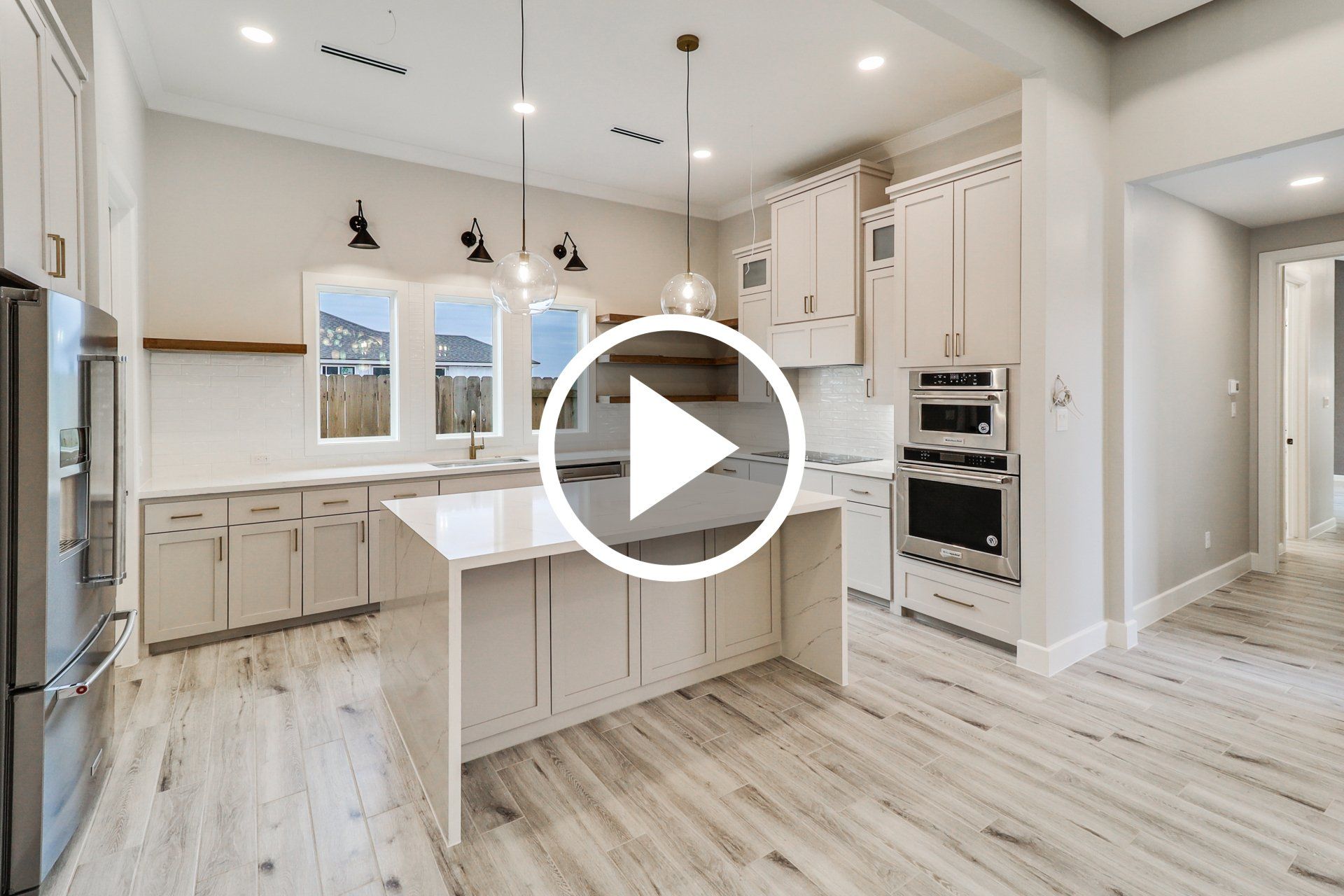 elegant modern kitchen with button to play video