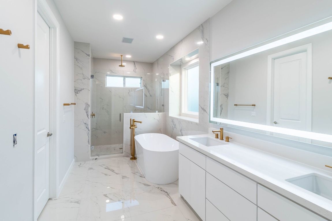 beautiful elegant white bathroom with marble finishes, bathtub and shower