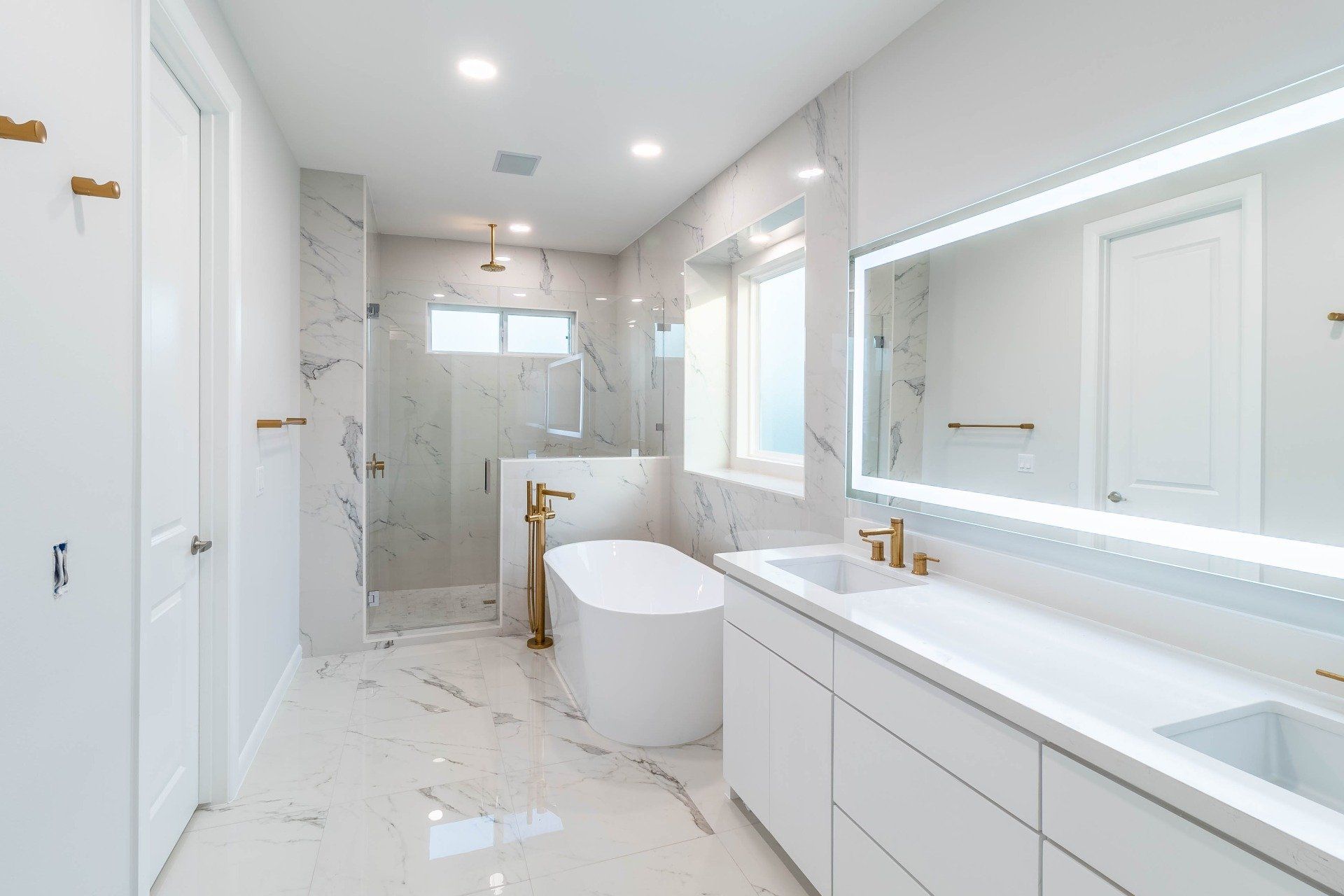 beautiful elegant white bathroom with marble finishes, bathtub and shower